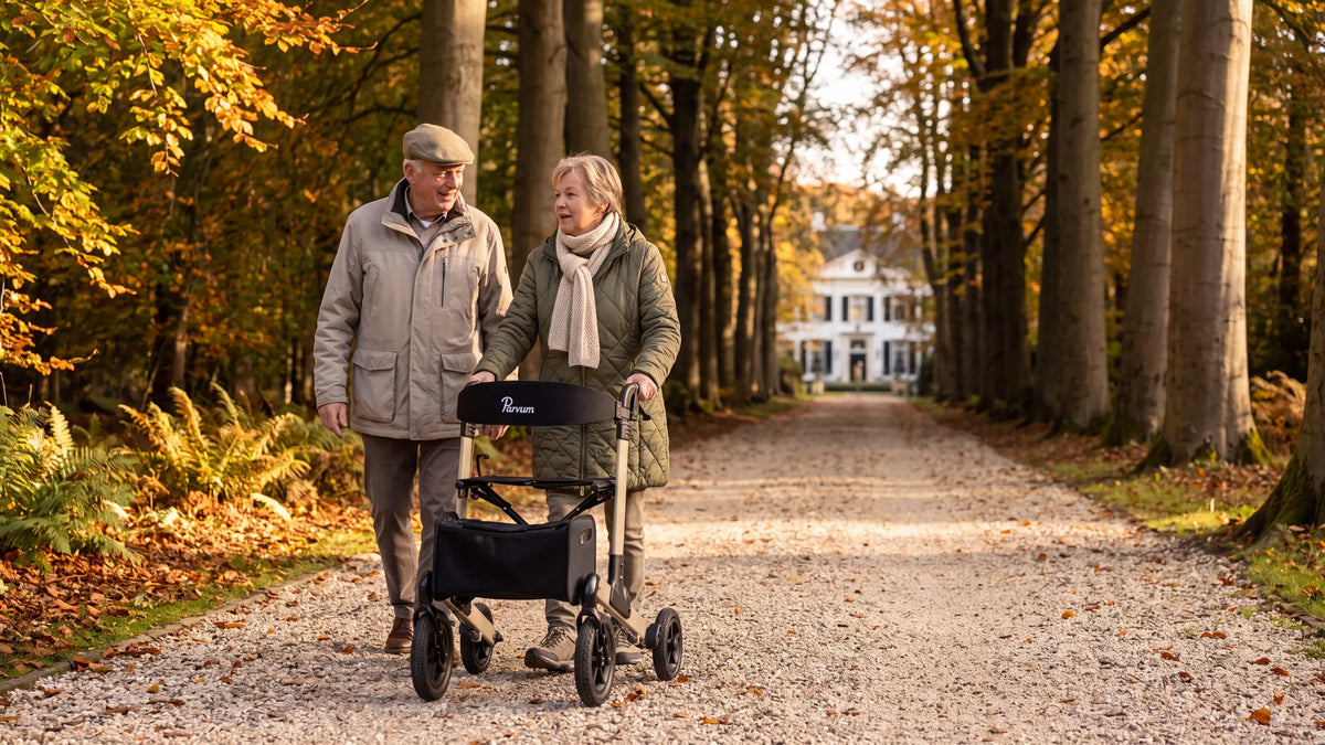 Parvum Luxo Air in champagne on an avenue of beech trees; a woman pushes the rollator, her husband walking beside her.
