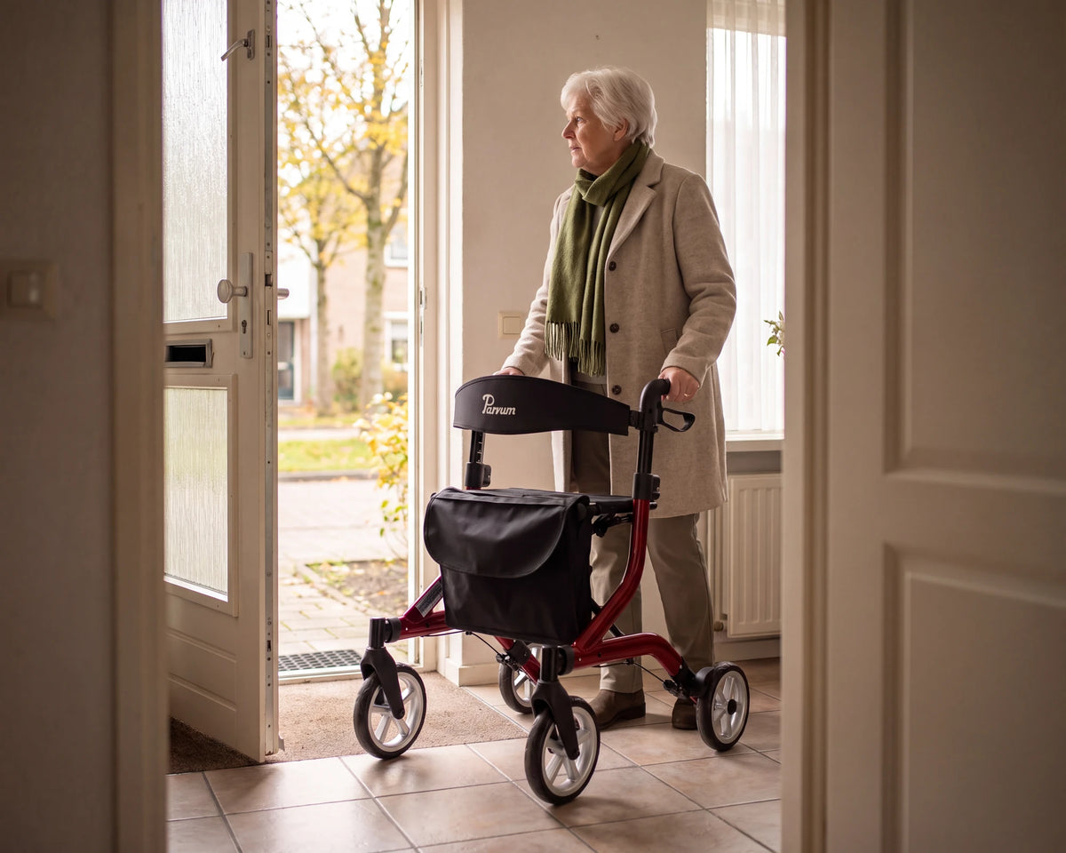 Parvum SuperLight in red in the hall by the open front door; a woman is ready to go outside.